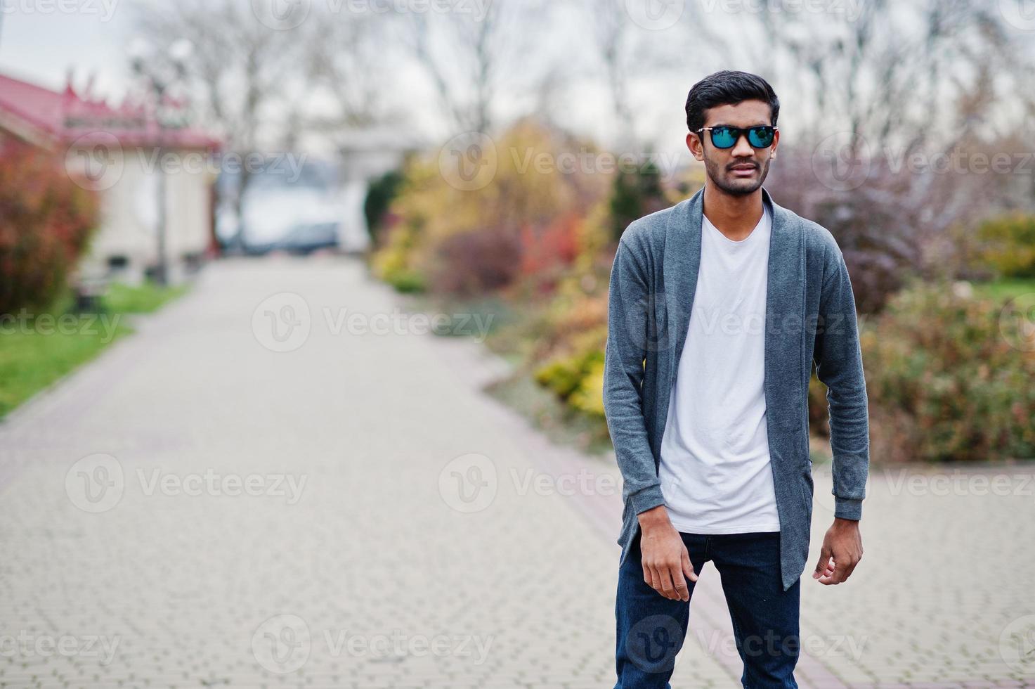 Stylish indian man at sunglasses wear casual posed outdoor. photo