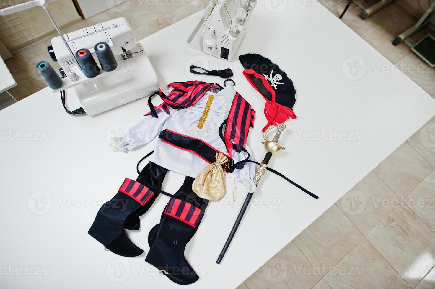 Children's carnival hand made boy costume at seamstress office on workplace. photo