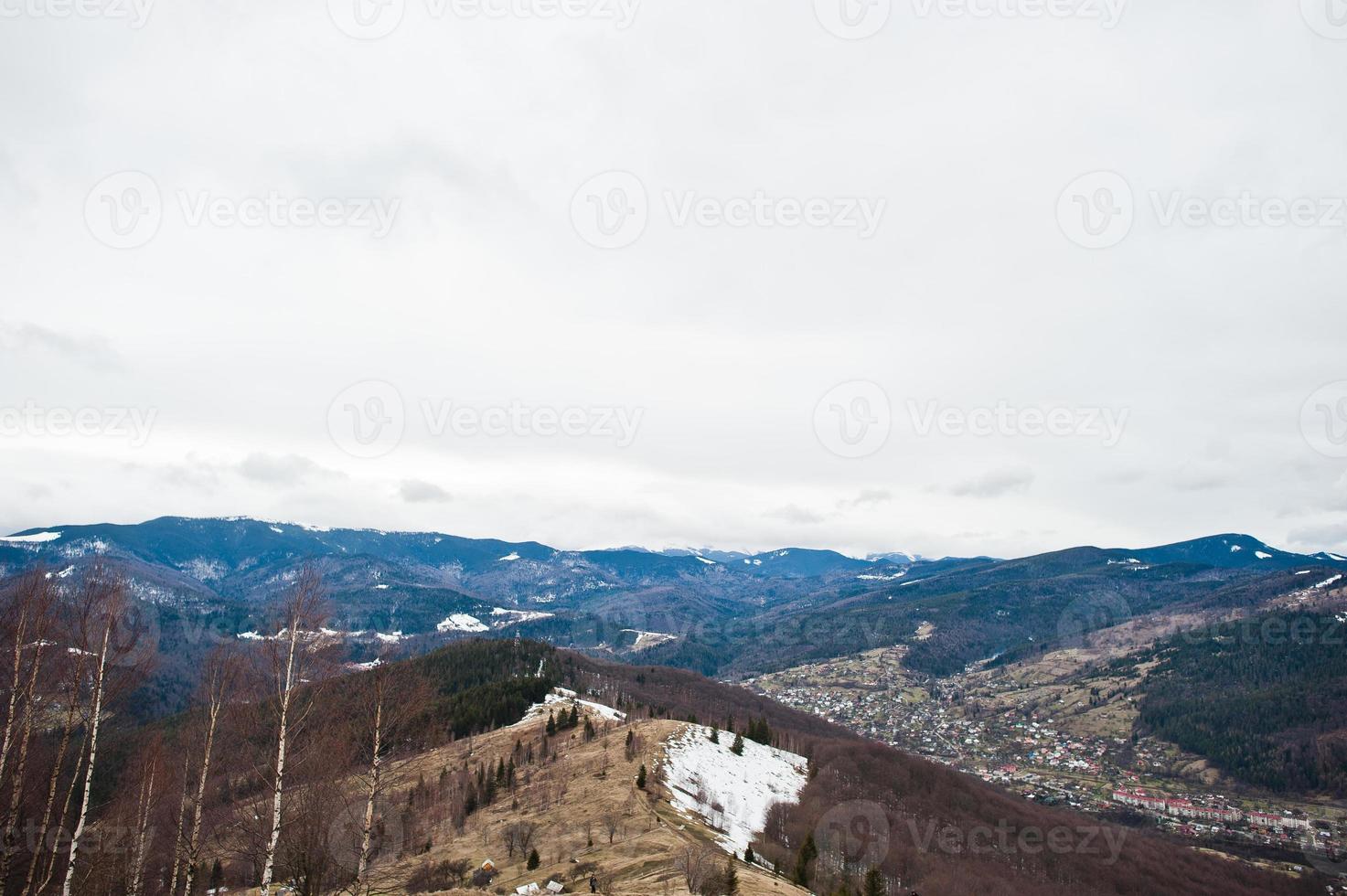 Snowy mountain valleys at Carpathian mountains. View of Ukrainian Carpathians and Yaremche from the top of Makovitsa. photo