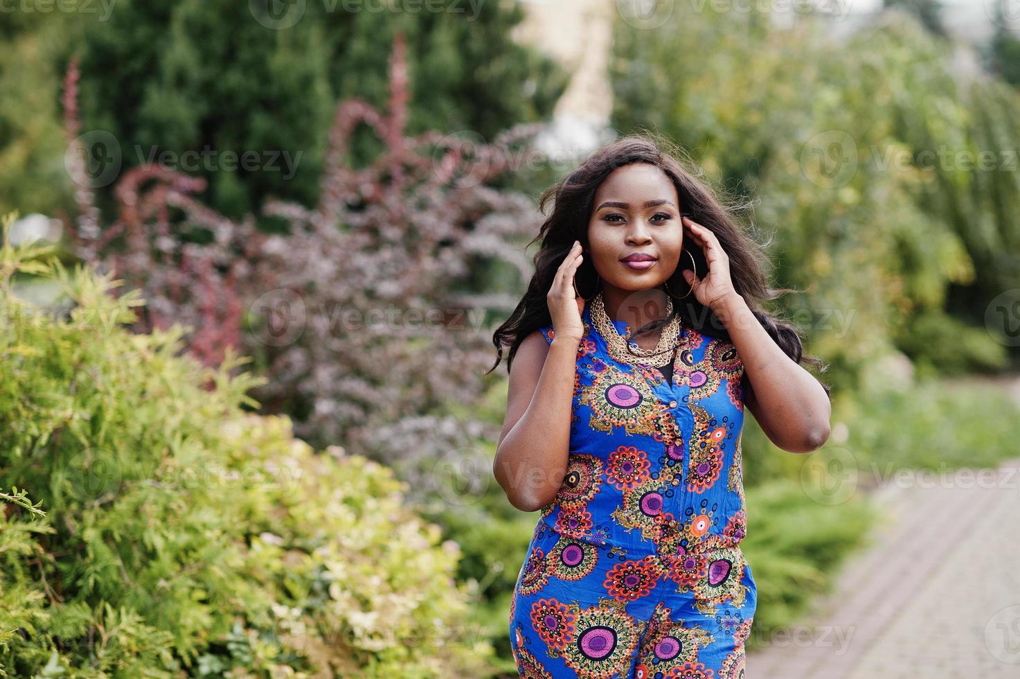 African american girl in coloured clothes posed outdoor. Fashionable black woman. photo