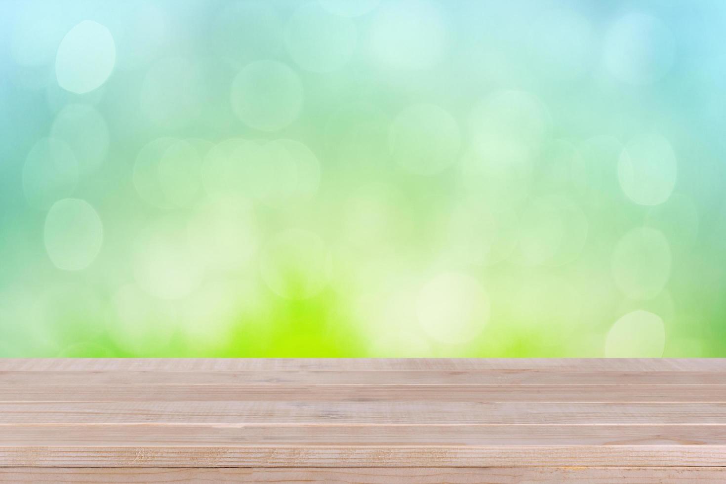 brown wood table top on bokeh abstract green background - can be used for montage or display your products photo