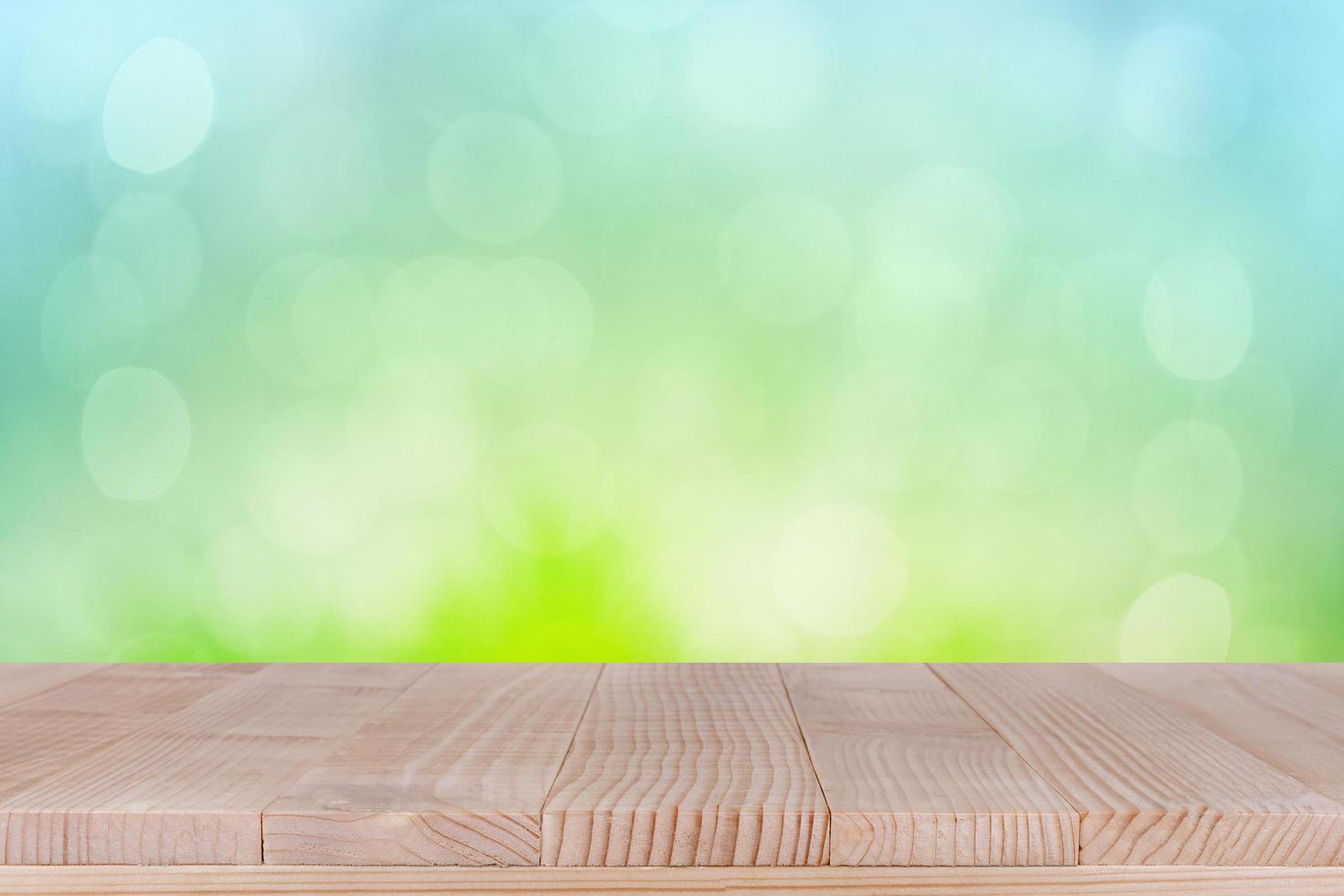 brown wood table top on bokeh abstract green background - can be used for montage or display your products photo