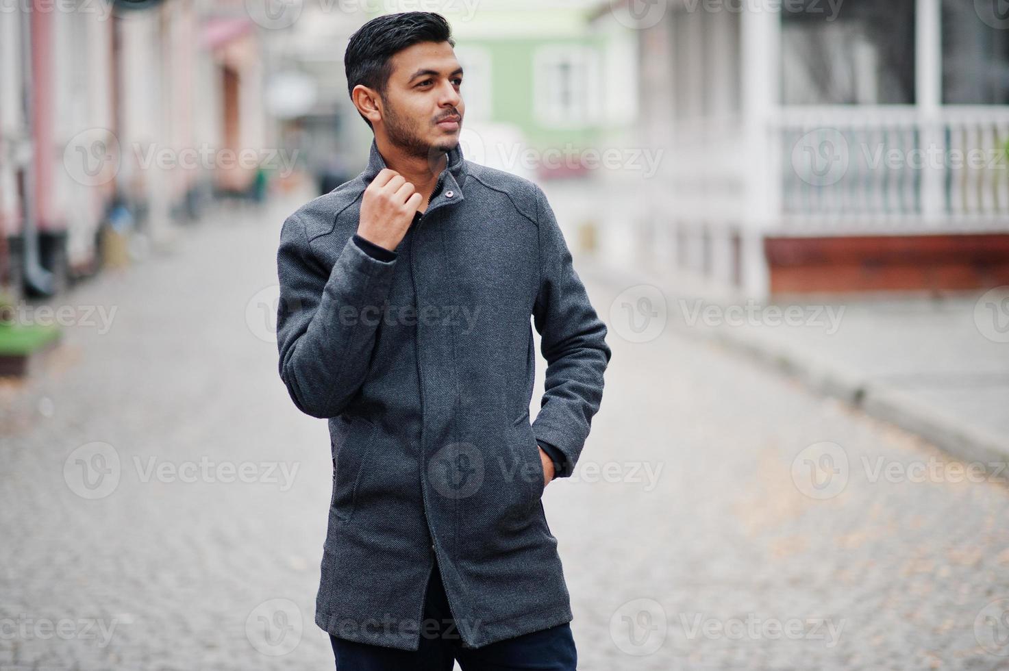 Stylish indian hindu man in gray coat posed on street. photo
