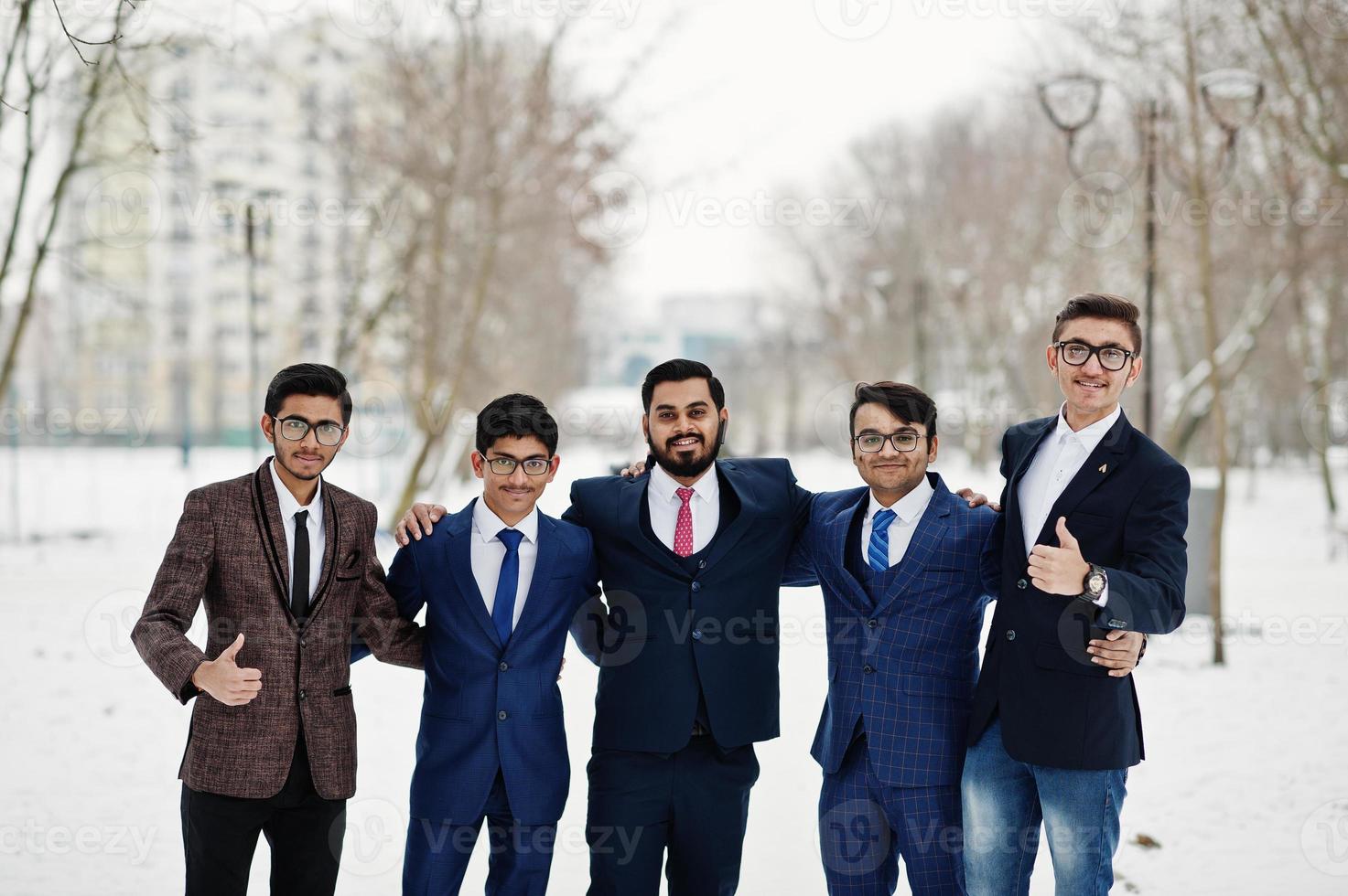 Group of five indian businessman in suits posed outdoor in winter day at Europe. photo