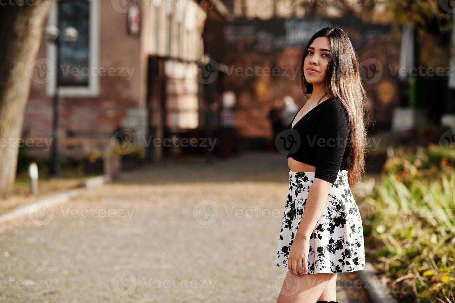 Pretty latino model girl from Ecuador wear on black tops and skirt posed at street. photo