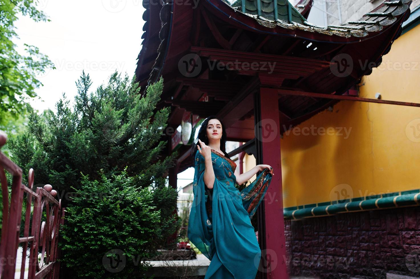 Portrait of beautiful indian brumette girl or hindu woman model against japanese traditional house. photo