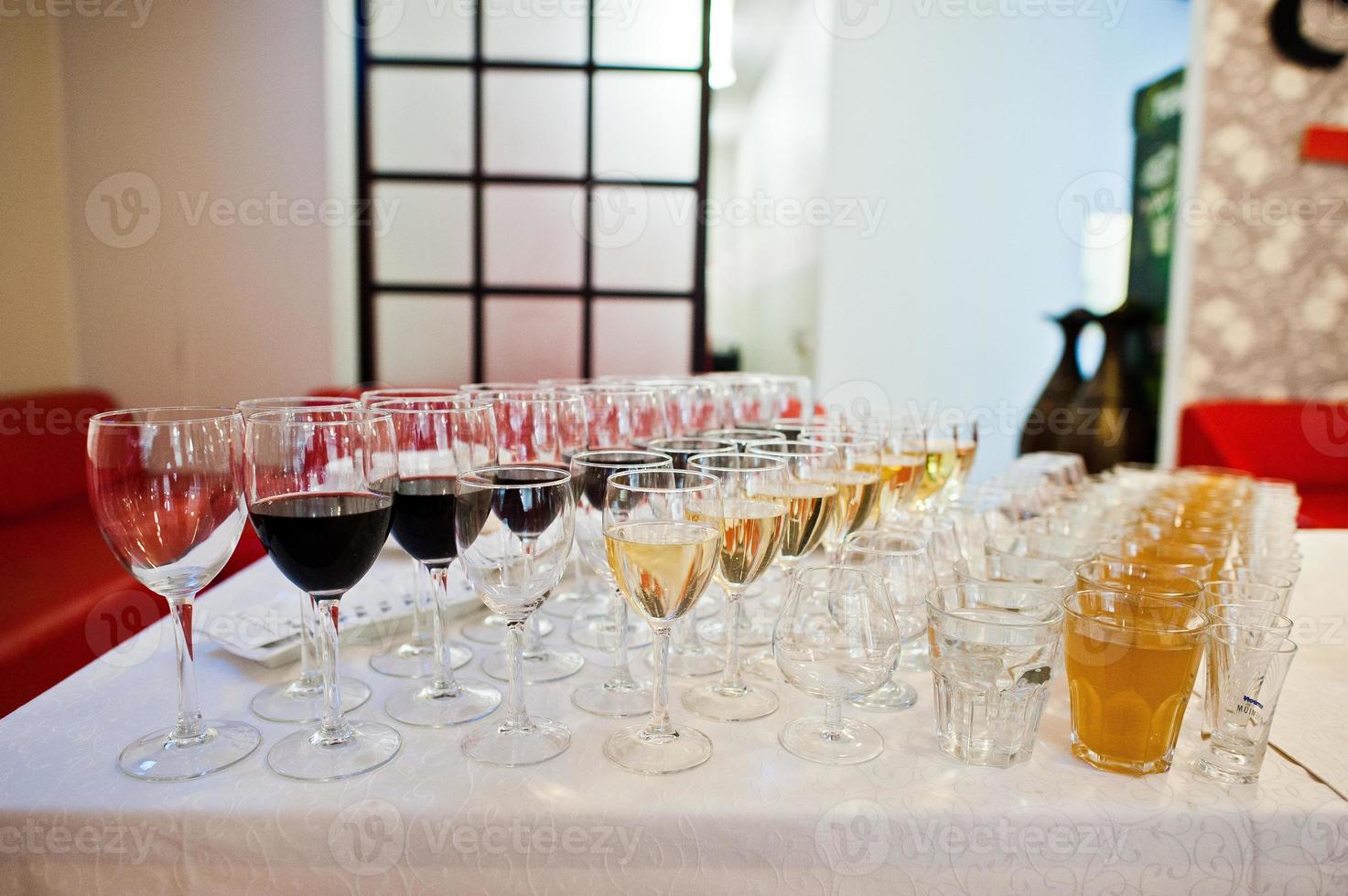 Different alcohol beverages in glasses on the table in restaurant or bar. photo