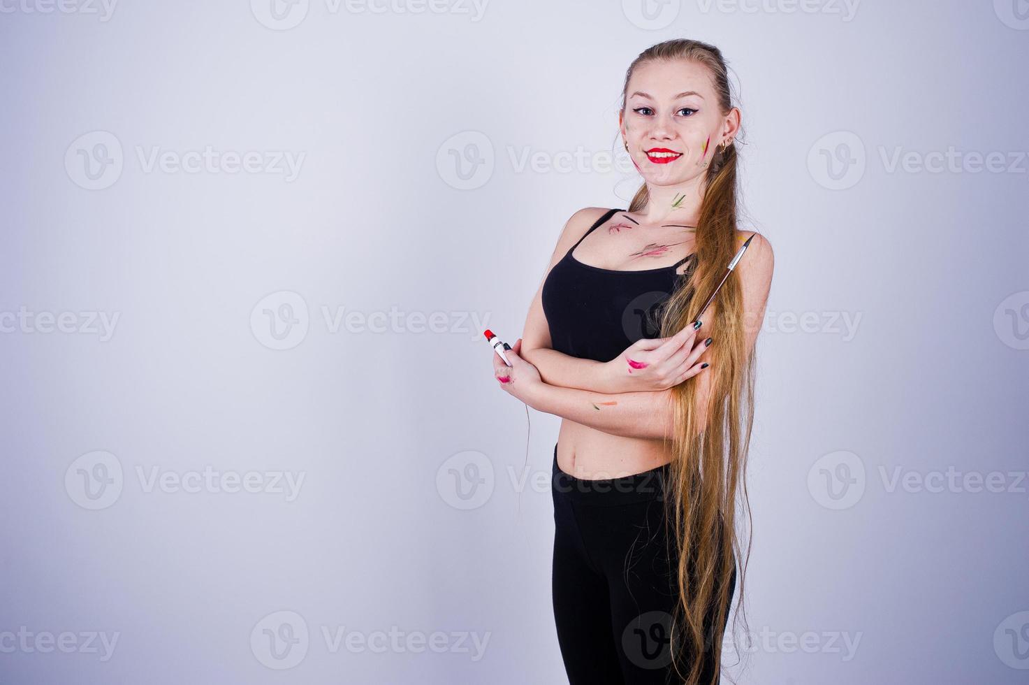 Beautiful woman artist painter with brushes posing in studio isolated on white. photo