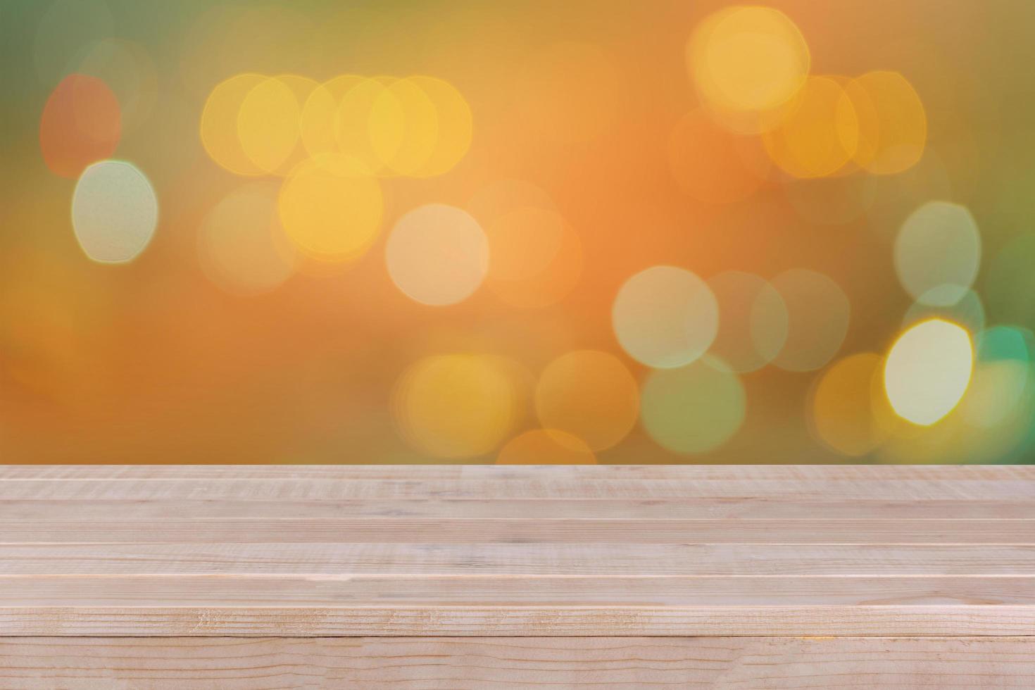 Wood table top on bokeh orange background photo