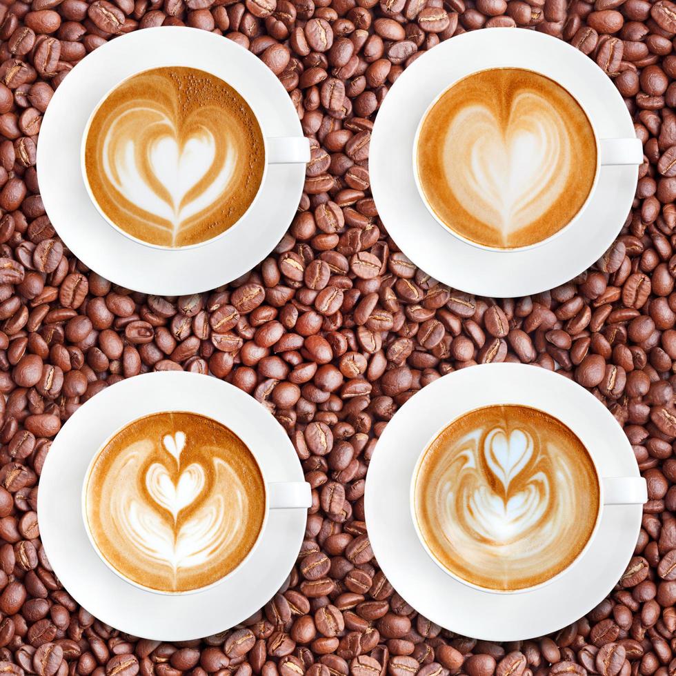 Latte art coffee on roasted coffee beans background photo