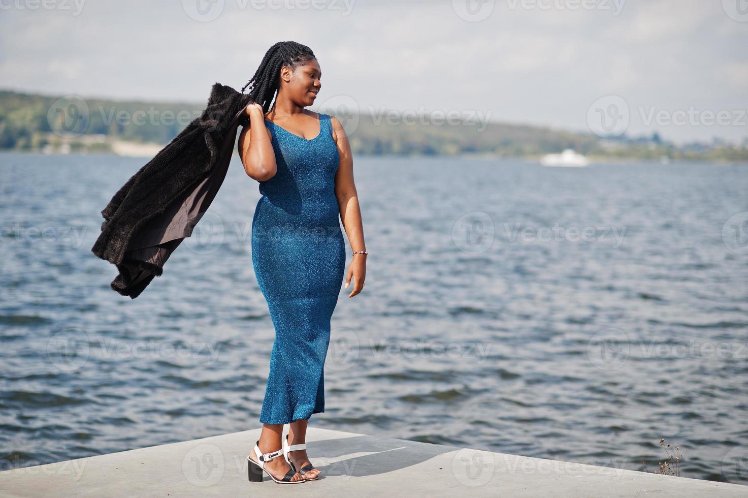 African american dark skinned plus size model posed in a blue