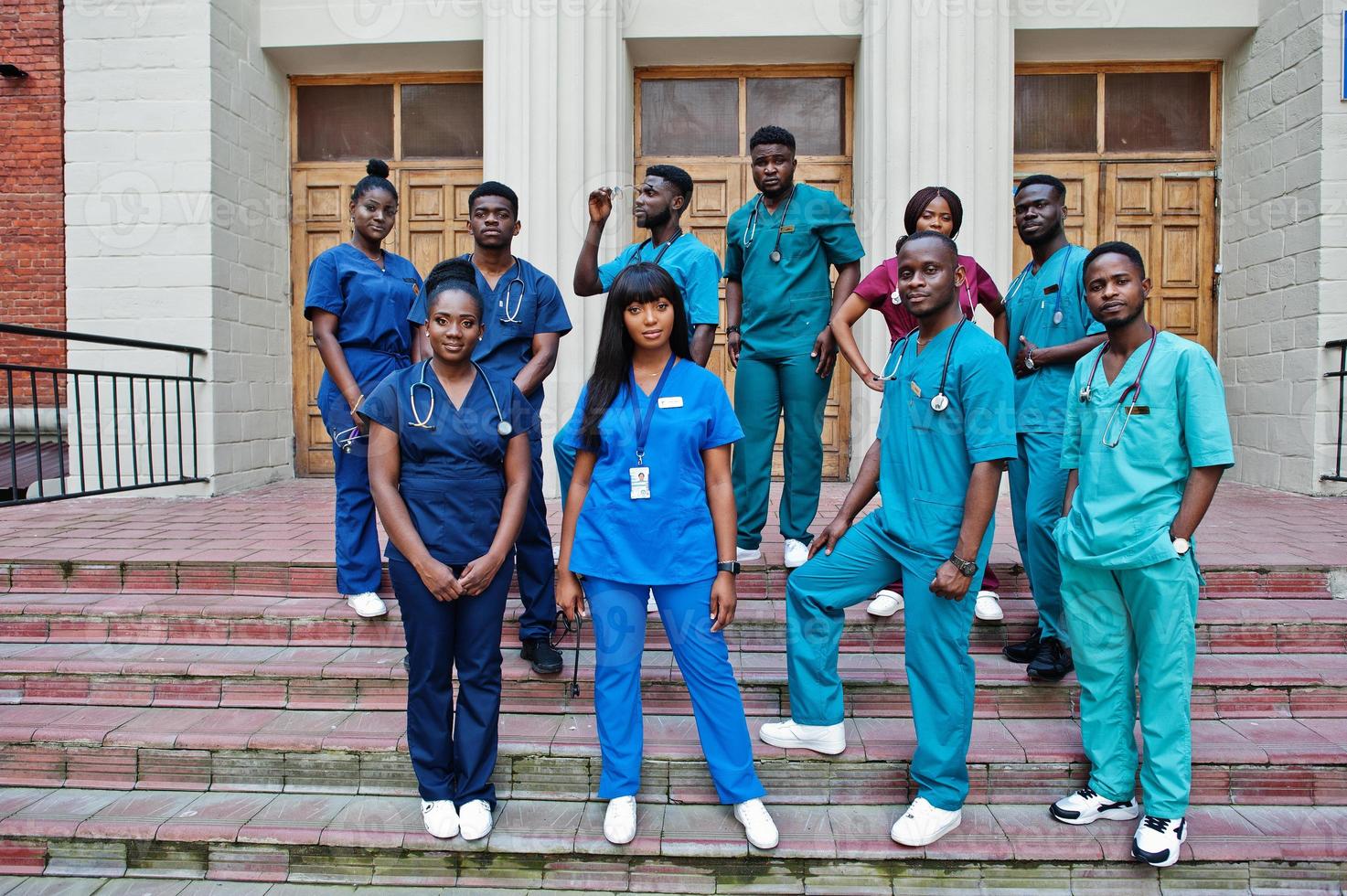 Group of african medical students posed outdoor against university door. photo