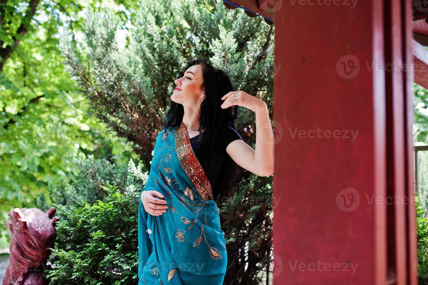 Portrait of beautiful indian brumette girl or hindu woman model against japanese traditional house. photo