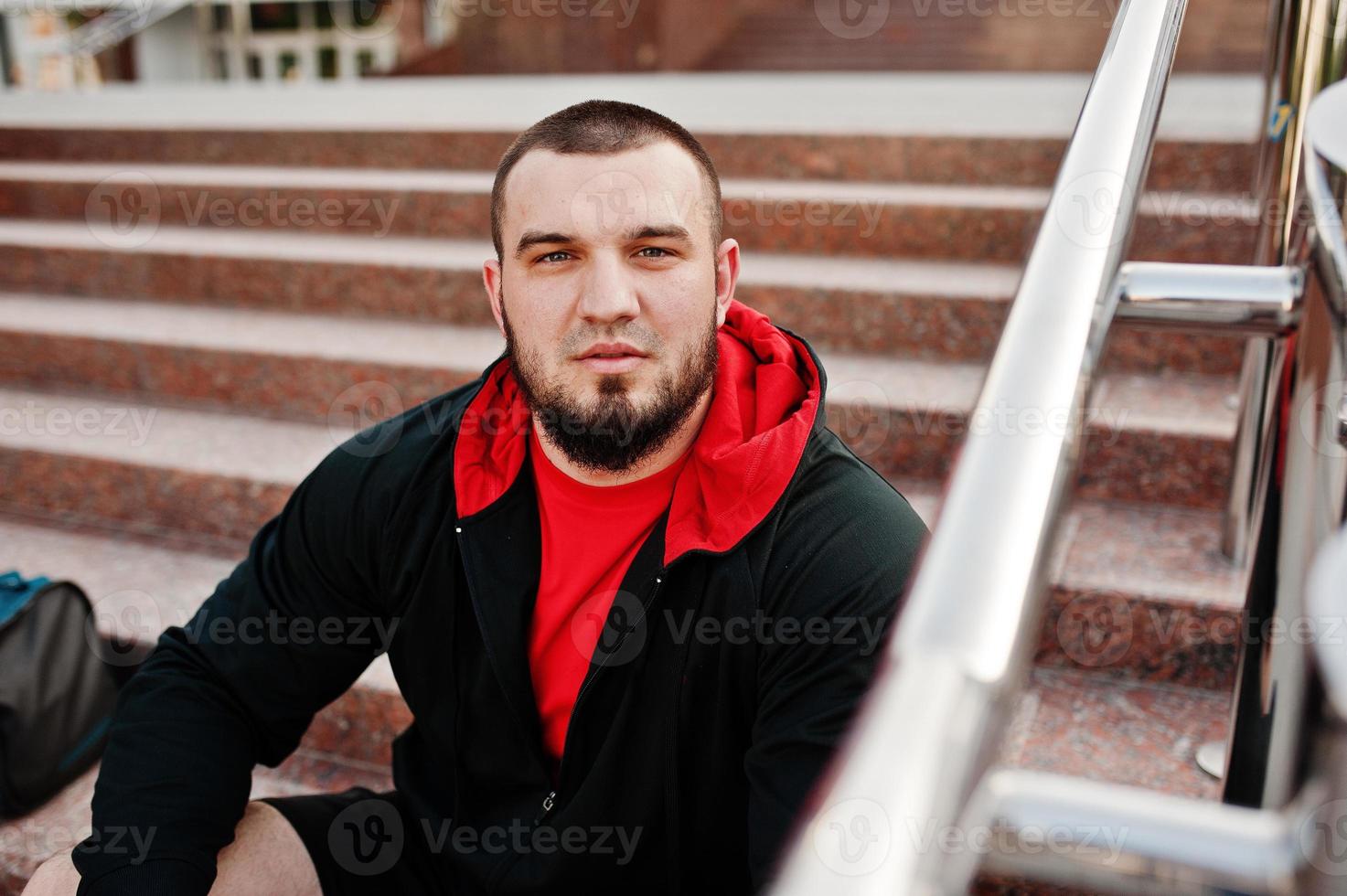 Young brutal bearded muscular man wear on sport suit. photo