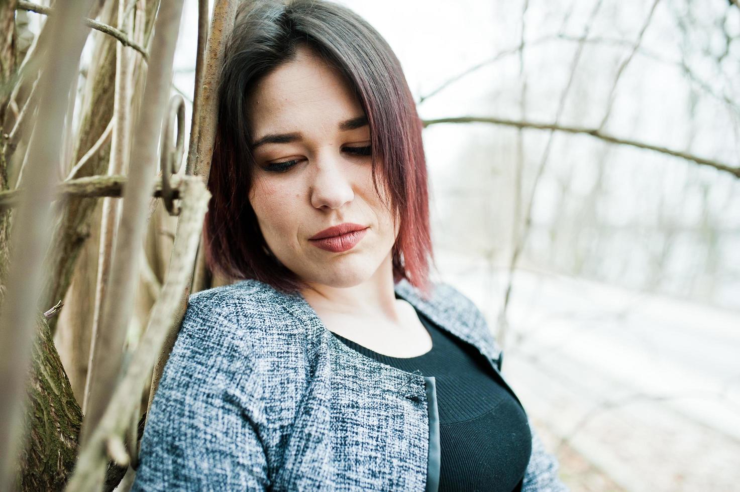 Portrait of brunette girl in black dress at spring wood. photo