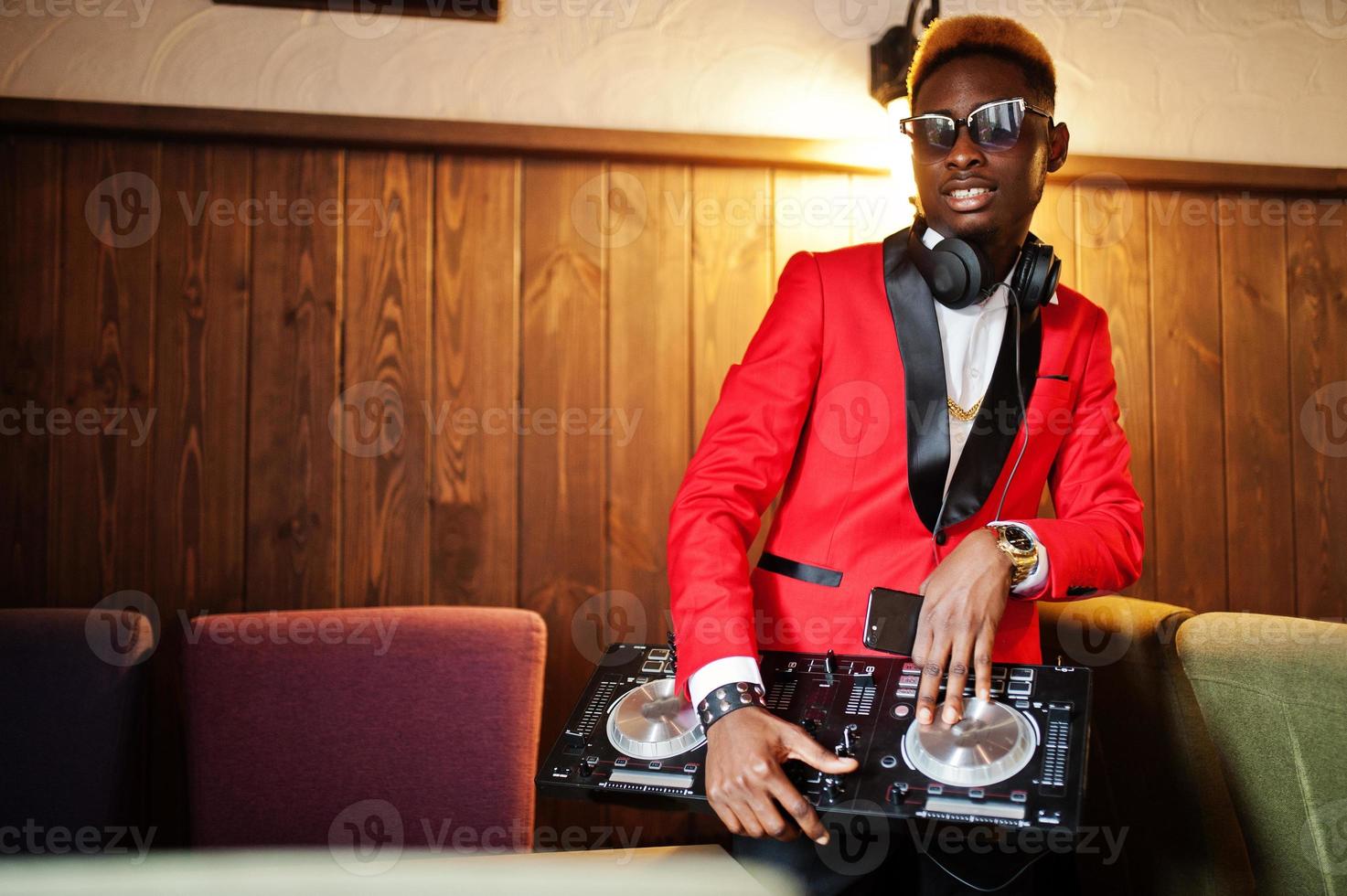 Fashion african american man model DJ at red suit with dj controller. photo