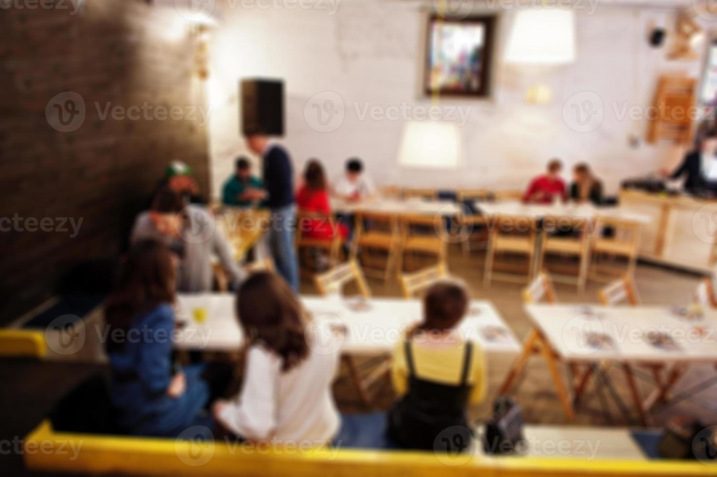 Master class and study concept. Abstract blurred photo of conference or seminar room with speaker on the stage.