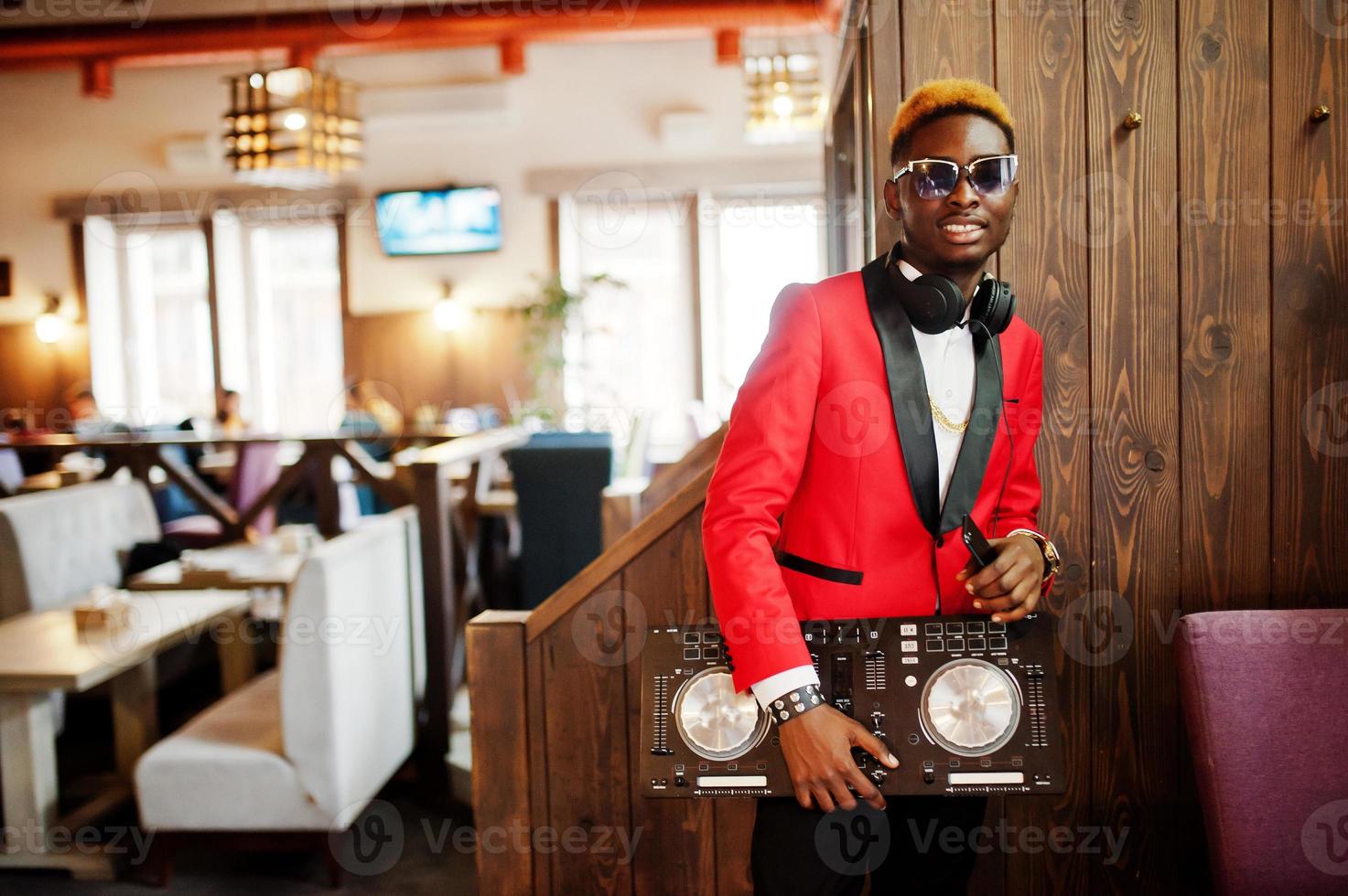 Fashion african american man model DJ at red suit with dj controller. photo