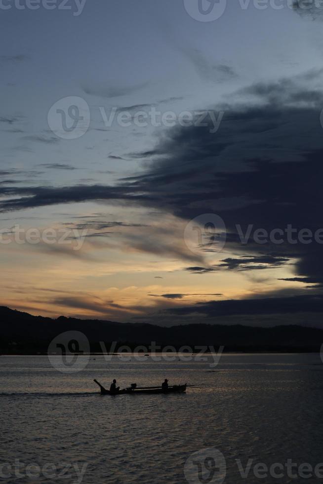 Fisherman on His Boat at Sunset. Fishermen Boat at Sunset photo