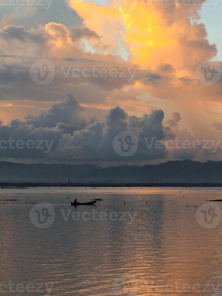 Fisherman on His Boat at Sunset. Fishermen Boat at Sunset photo