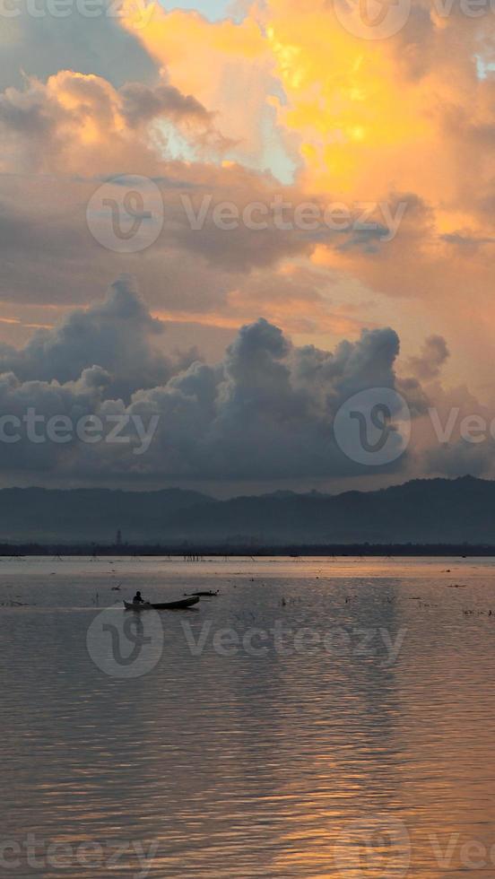 Fisherman Silhouette on His Boat photo