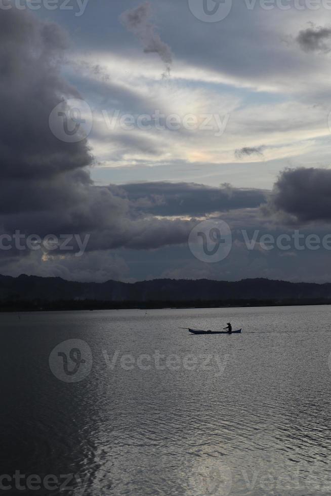 Fisherman on His Boat at Sunset. Fishermen Boat at Sunset photo