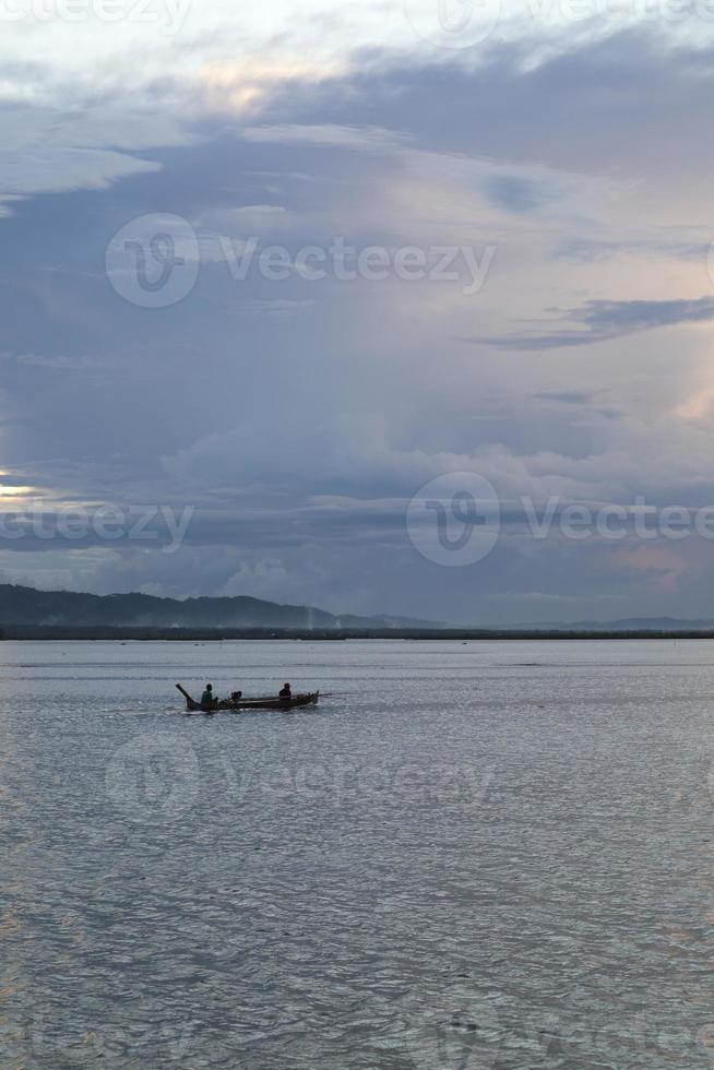 Fisherman on His Boat at Sunset. Fishermen Boat at Sunset photo