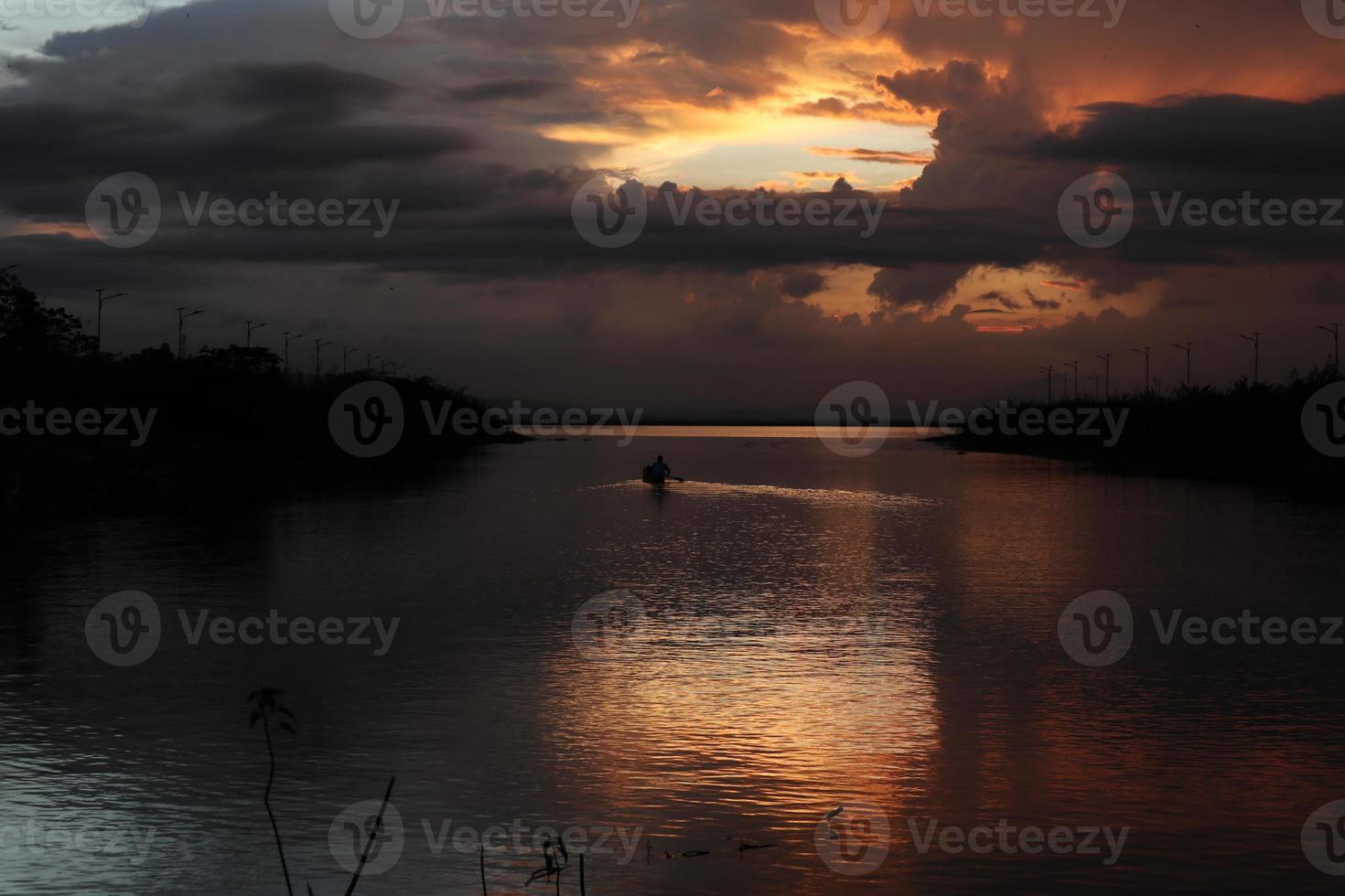 Fisherman on His Boat at Sunset. Fishermen Boat at Sunset photo