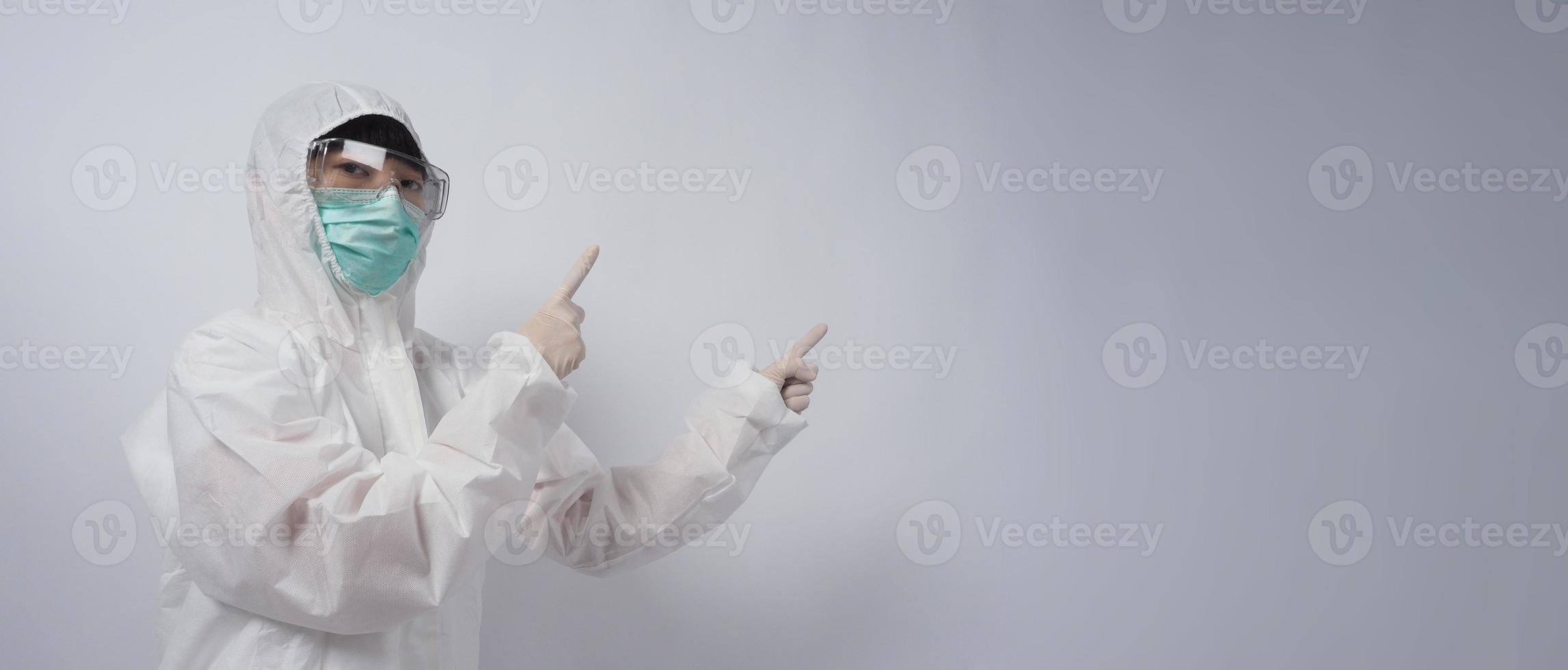 Doctor in PPE suit gesture make hand sign. Represent victory win over virus. photo