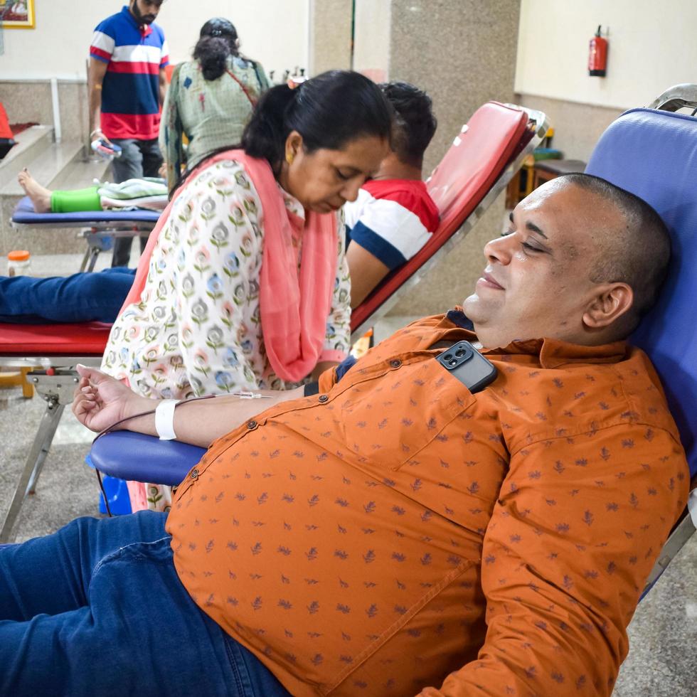 Delhi, India, June 19 2022 - Blood donor at Blood donation camp held at Balaji Temple, Vivek Vihar, Delhi, India, Image for World blood donor day on June 14 every year, Blood Donation Camp at Temple photo