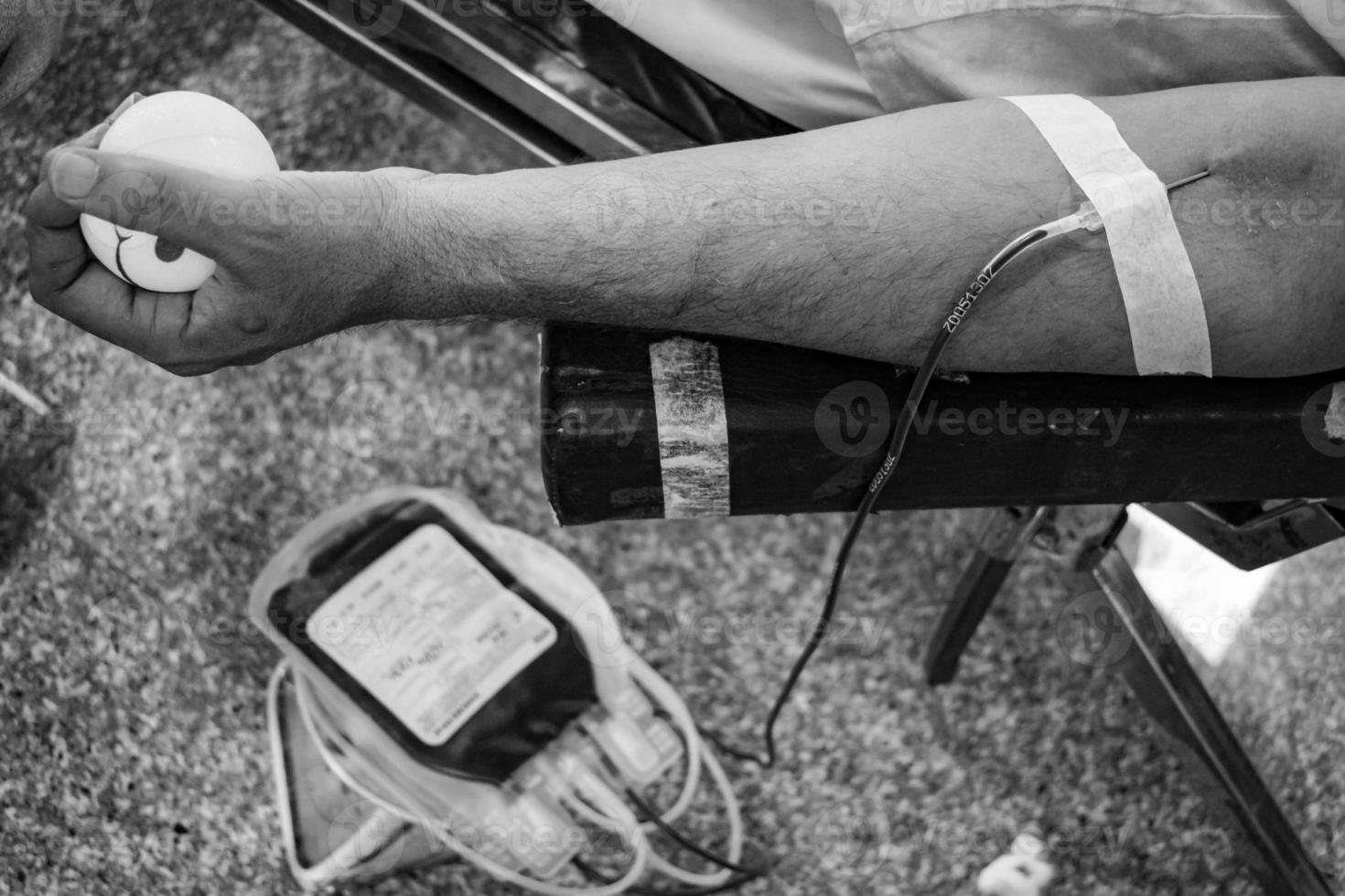 Blood donor at Blood donation camp held with a bouncy ball holding in hand at Balaji Temple, Vivek Vihar, Delhi, India, Image for World blood donor day on June 14 every year, Blood Donation Camp photo