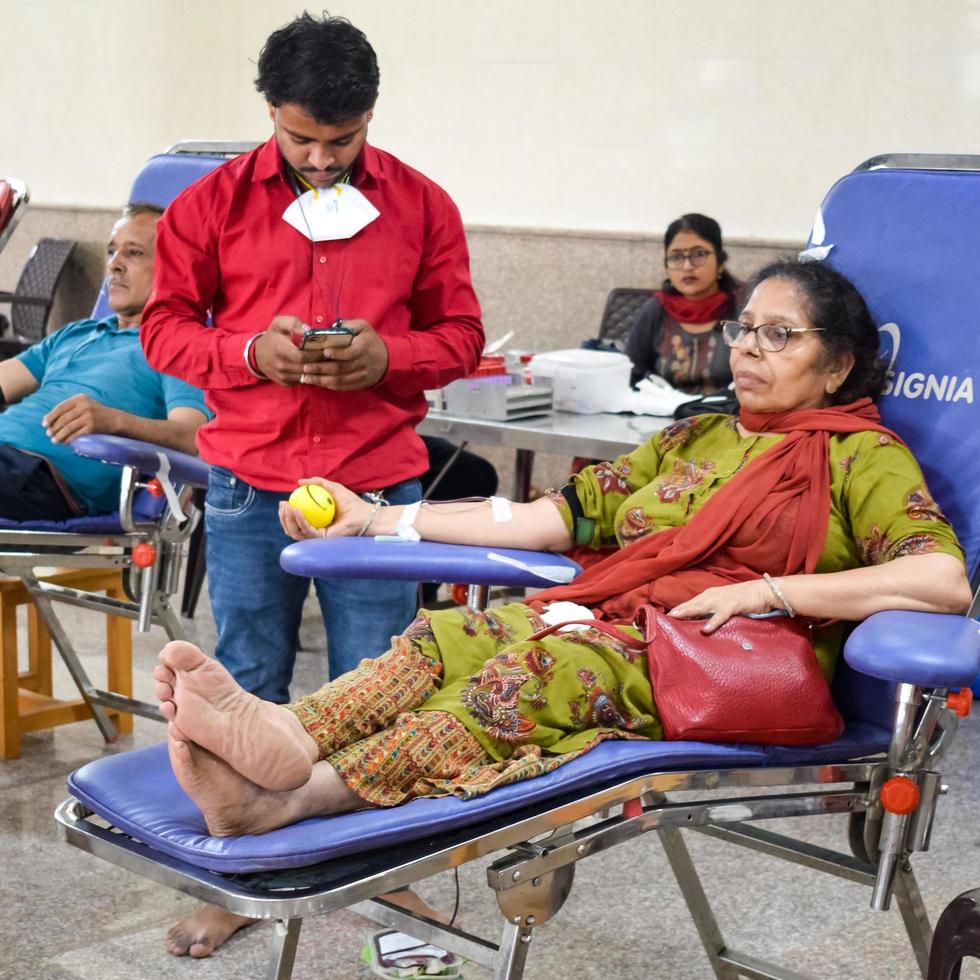 Delhi, India, June 19 2022 - Blood donor at Blood donation camp held at Balaji Temple, Vivek Vihar, Delhi, India, Image for World blood donor day on June 14 every year, Blood Donation Camp at Temple photo
