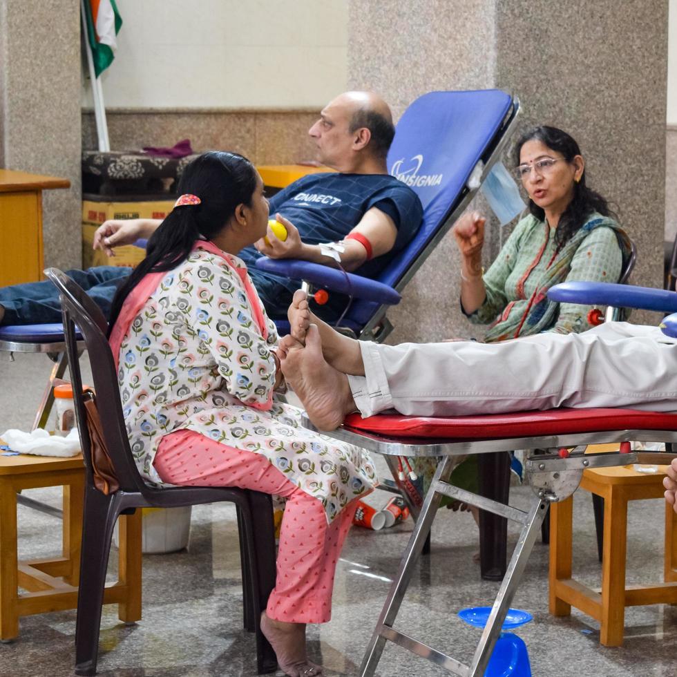 Delhi, India, June 19 2022 - Blood donor at Blood donation camp held at Balaji Temple, Vivek Vihar, Delhi, India, Image for World blood donor day on June 14 every year, Blood Donation Camp at Temple photo