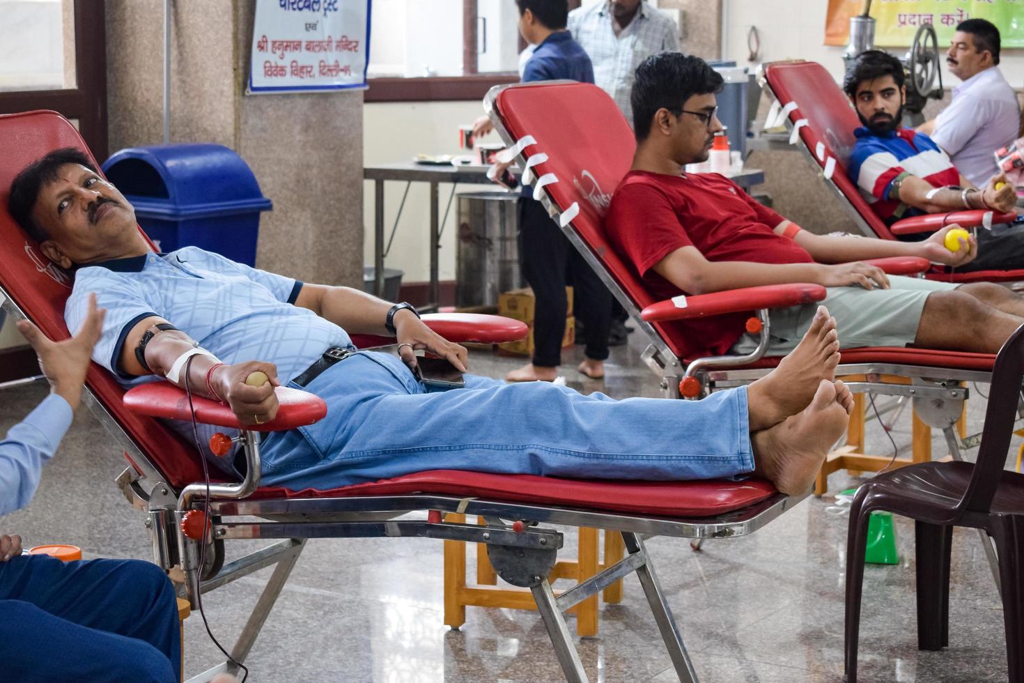 Delhi, India, June 19 2022 - Blood donor at Blood donation camp held at Balaji Temple, Vivek Vihar, Delhi, India, Image for World blood donor day on June 14 every year, Blood Donation Camp at Temple photo