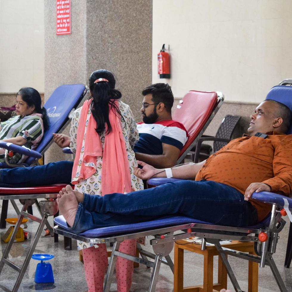 Delhi, India, June 19 2022 - Blood donor at Blood donation camp held at Balaji Temple, Vivek Vihar, Delhi, India, Image for World blood donor day on June 14 every year, Blood Donation Camp at Temple photo