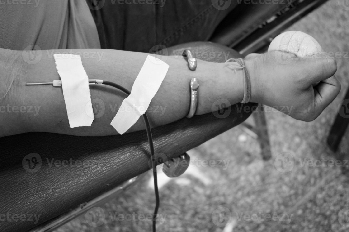 Blood donor at Blood donation camp held with a bouncy ball holding in hand at Balaji Temple, Vivek Vihar, Delhi, India, Image for World blood donor day on June 14 every year, Blood Donation Camp photo