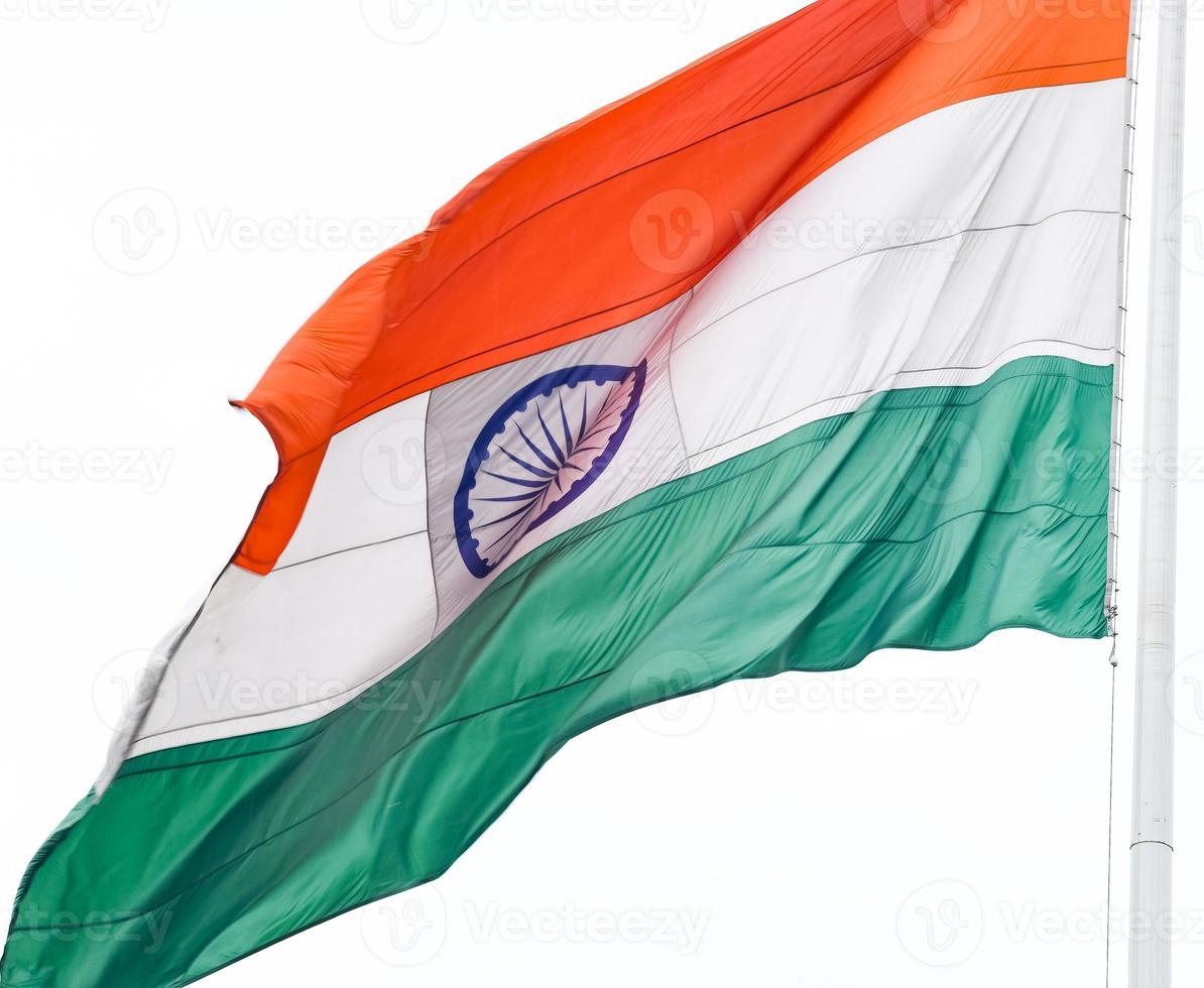 India flag flying high at Connaught Place with pride in blue sky, India flag fluttering, Indian Flag on Independence Day and Republic Day of India, tilt up shot, Waving Indian flag, Har Ghar Tiranga photo