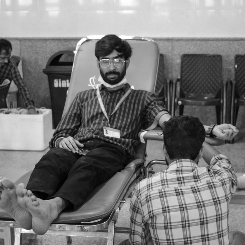Delhi, India, June 19 2022 - Blood donor at Blood donation camp held at Balaji Temple, Vivek Vihar, Delhi, India, Image for World blood donor day on June 14 every year, Blood Donation Camp at Temple photo