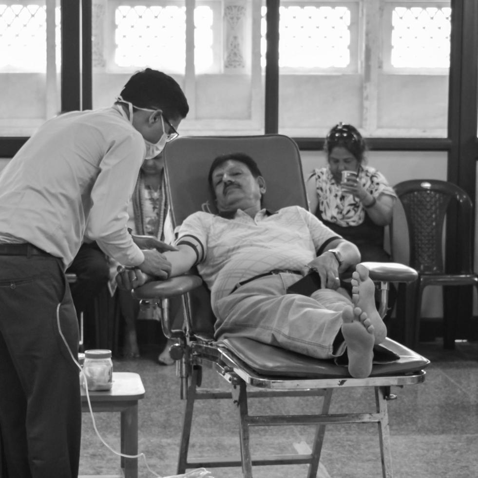 Delhi, India, June 19 2022 - Blood donor at Blood donation camp held at Balaji Temple, Vivek Vihar, Delhi, India, Image for World blood donor day on June 14 every year, Blood Donation Camp at Temple photo