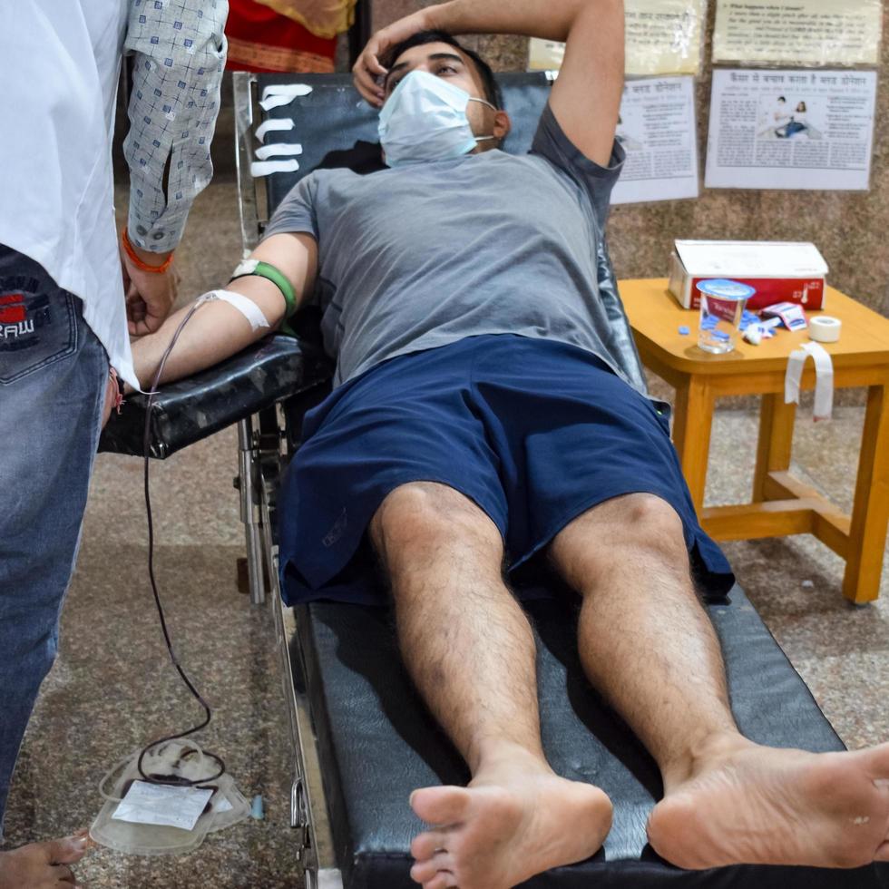 Delhi, India, June 19 2022 - Blood donor at Blood donation camp held at Balaji Temple, Vivek Vihar, Delhi, India, Image for World blood donor day on June 14 every year, Blood Donation Camp at Temple photo