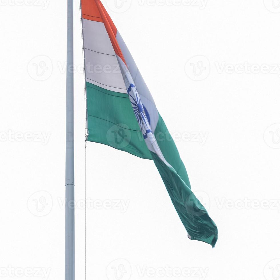 India flag flying high at Connaught Place with pride in blue sky, India flag fluttering, Indian Flag on Independence Day and Republic Day of India, tilt up shot, Waving Indian flag, Har Ghar Tiranga photo