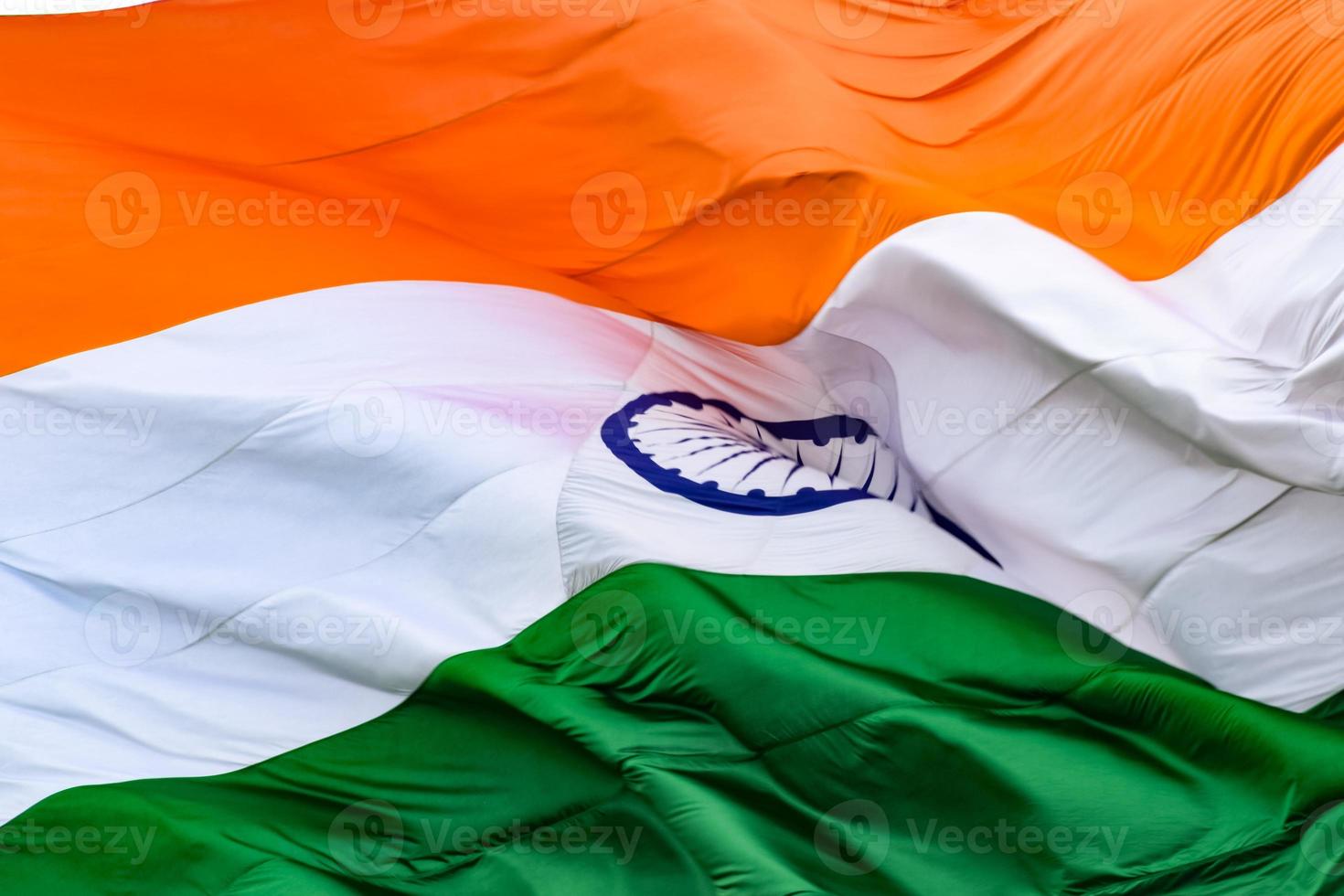 India flag flying high at Connaught Place with pride in blue sky, India flag fluttering, Indian Flag on Independence Day and Republic Day of India, tilt up shot, Waving Indian flag, Har Ghar Tiranga photo