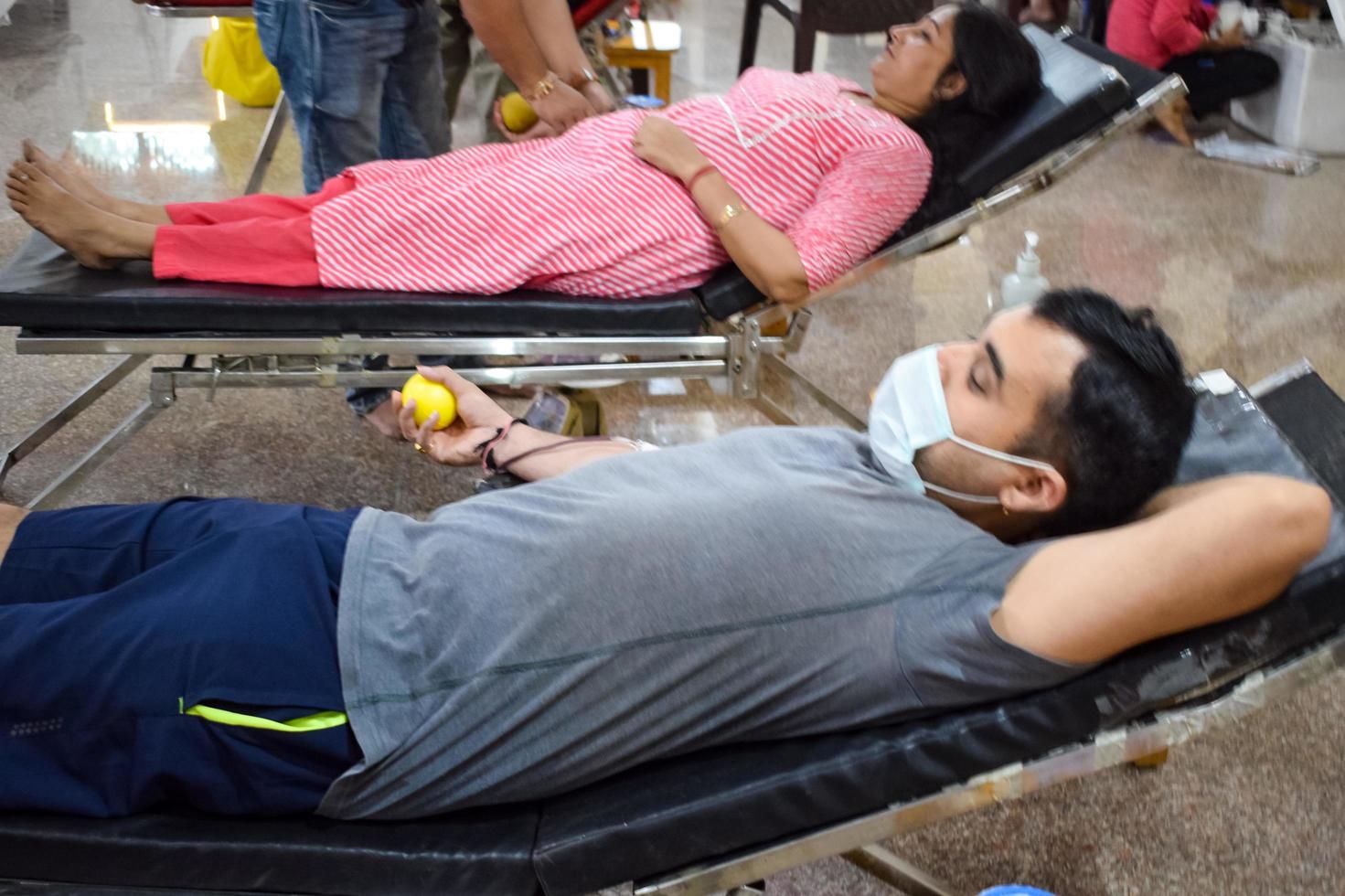 Delhi, India, June 19 2022 - Blood donor at Blood donation camp held at Balaji Temple, Vivek Vihar, Delhi, India, Image for World blood donor day on June 14 every year, Blood Donation Camp at Temple photo