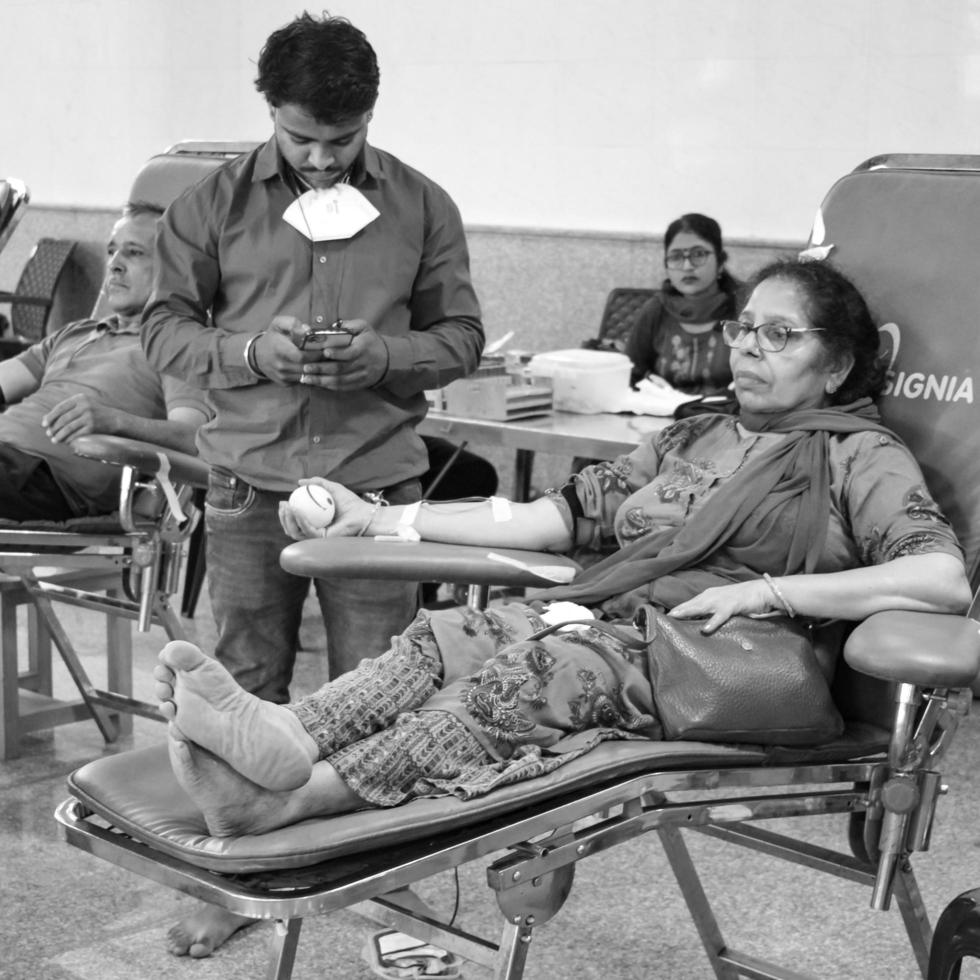 Delhi, India, June 19 2022 - Blood donor at Blood donation camp held at Balaji Temple, Vivek Vihar, Delhi, India, Image for World blood donor day on June 14 every year, Blood Donation Camp at Temple photo