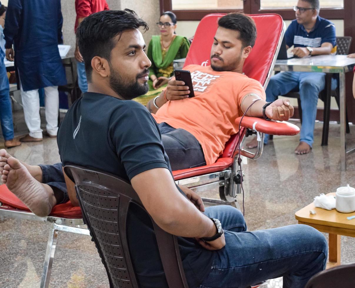 Delhi, India, June 19 2022 - Blood donor at Blood donation camp held at Balaji Temple, Vivek Vihar, Delhi, India, Image for World blood donor day on June 14 every year, Blood Donation Camp at Temple photo