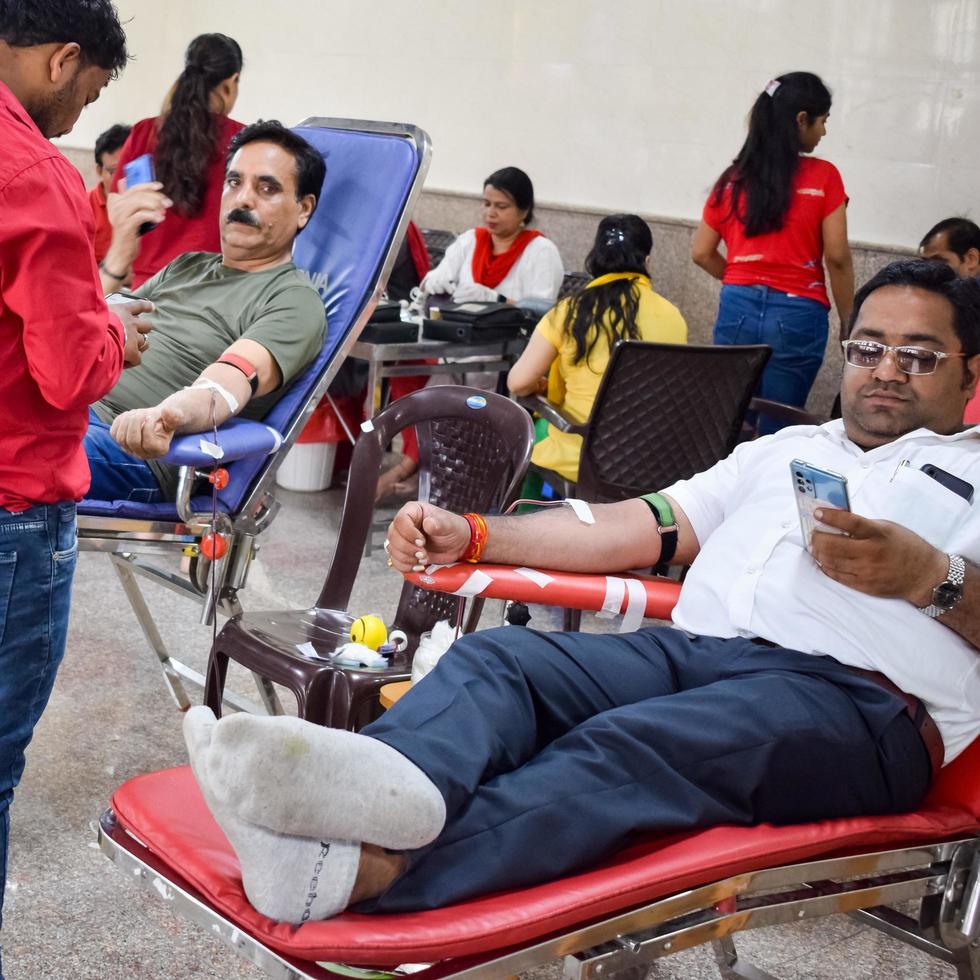 Delhi, India, June 19 2022 - Blood donor at Blood donation camp held at Balaji Temple, Vivek Vihar, Delhi, India, Image for World blood donor day on June 14 every year, Blood Donation Camp at Temple photo