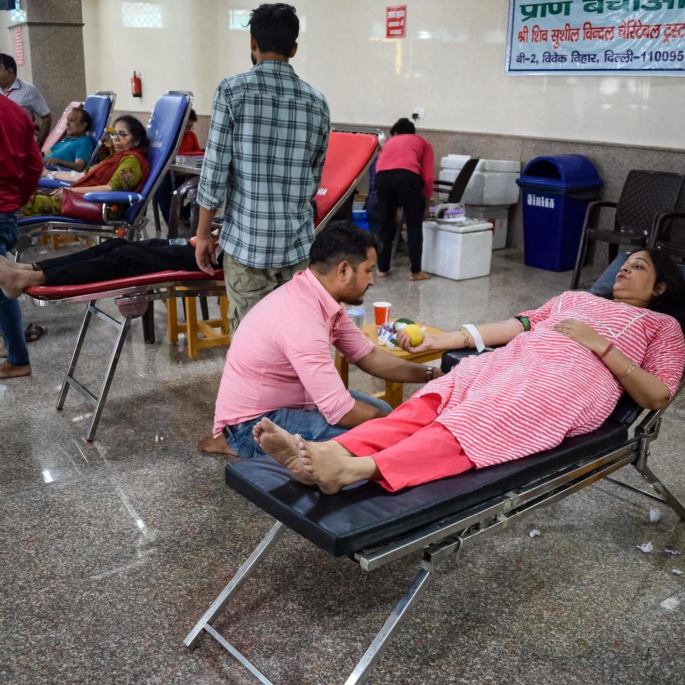 Delhi, India, June 19 2022 - Blood donor at Blood donation camp held at Balaji Temple, Vivek Vihar, Delhi, India, Image for World blood donor day on June 14 every year, Blood Donation Camp at Temple photo