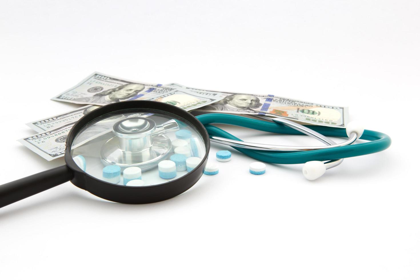 health care costs - Stethoscope on money background photo