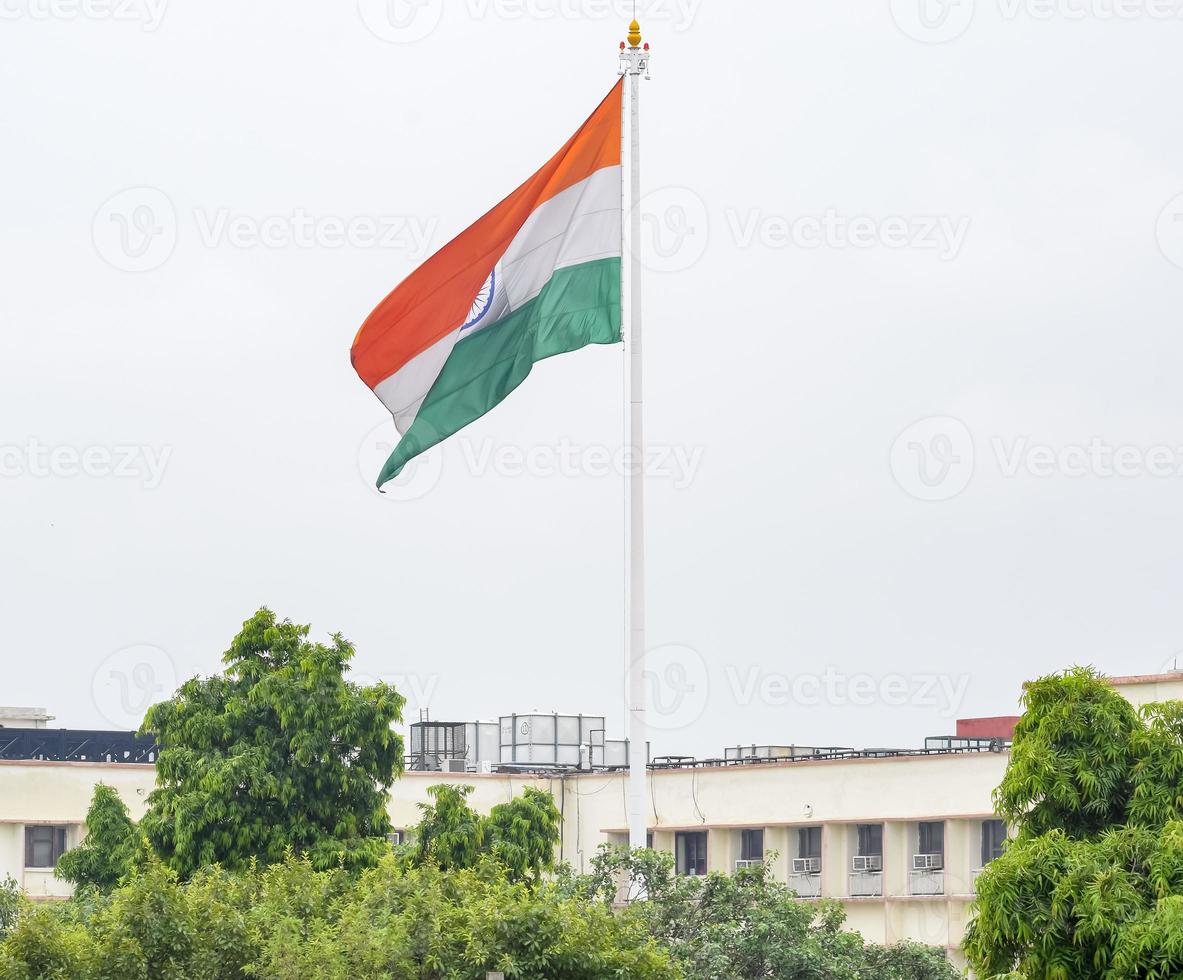 India flag flying high at Connaught Place with pride in blue sky, India flag fluttering, Indian Flag on Independence Day and Republic Day of India, tilt up shot, Waving Indian flag, Har Ghar Tiranga photo