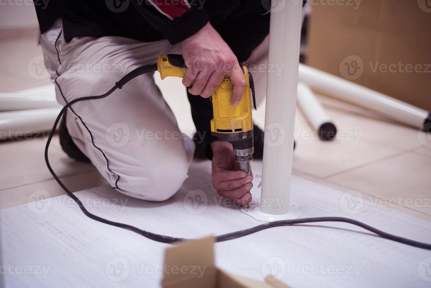 repairman working with drilling machine photo